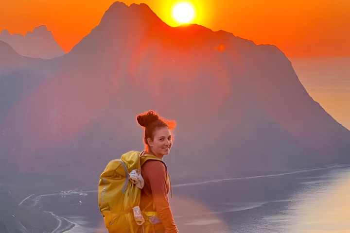 a man standing in front of a sunset