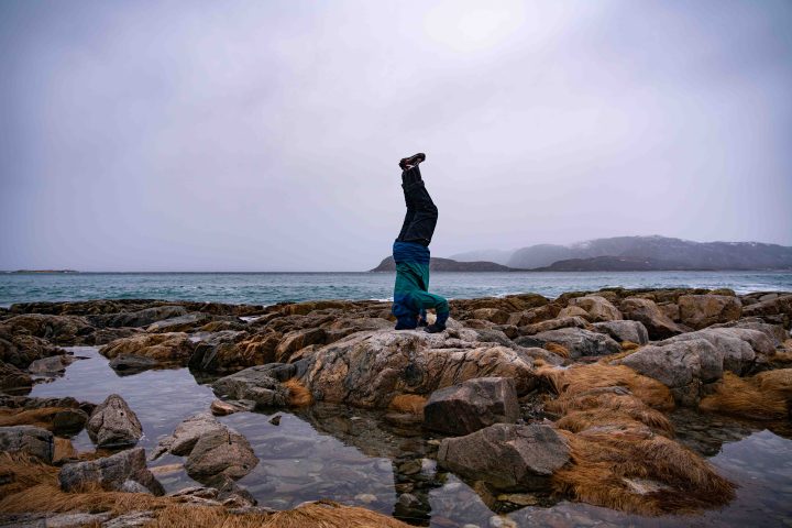 a person standing on a rocky beach