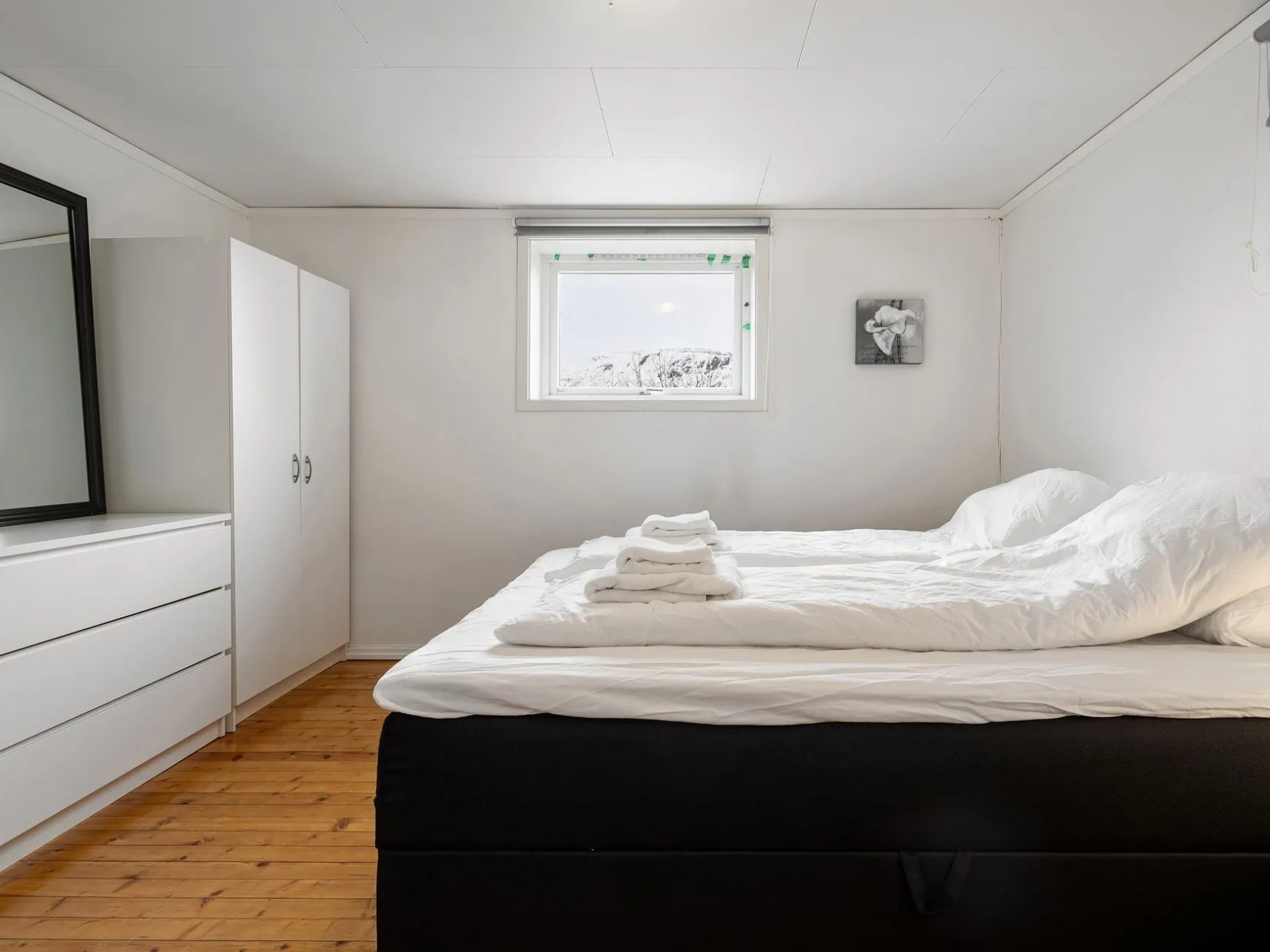 a bedroom with a bed in a room